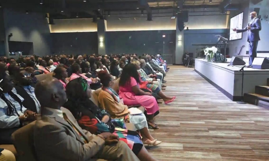 Bishop teaching a large gathered congregation
