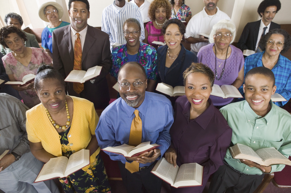 Congregation holding open Bibles together