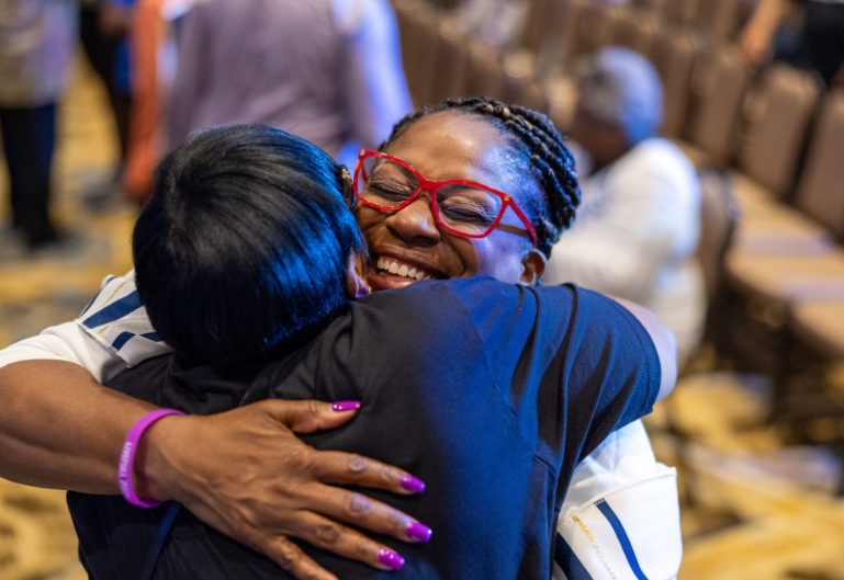 Two church members embracing warmly